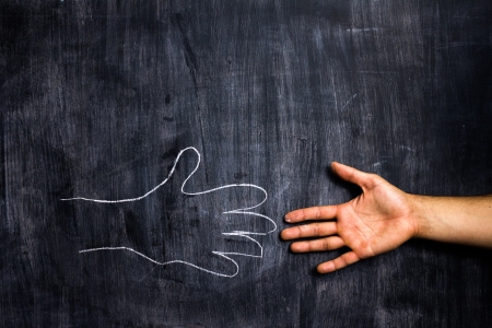 Shaking hands with blackboardの写真素材