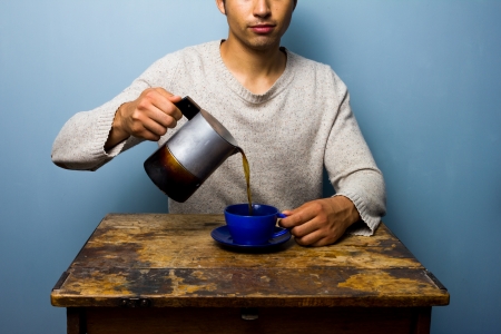 Man pouring coffee from moka potの写真素材