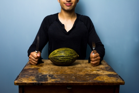 Man about to eat melonの写真素材