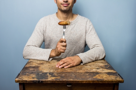 Man eating sausageの写真素材
