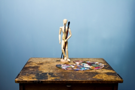 Artist s dummy and palette with paintの写真素材