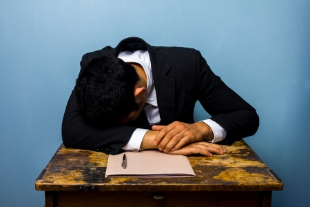 businessman is asleep at an old deskの写真素材