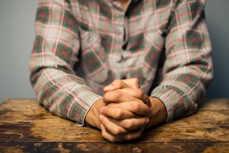 Man at desk with his hands foldedの写真素材