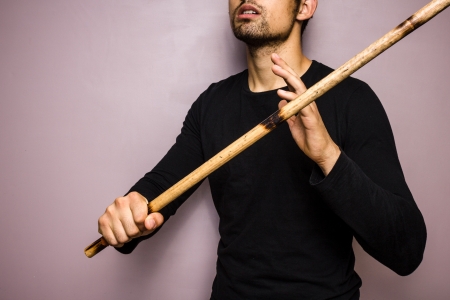 Young man practising eskrima stick fightingの写真素材