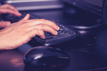 Close up man s hands typing computer keyboard