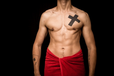 Athletic and muscular young man posing on black backgroundの写真素材