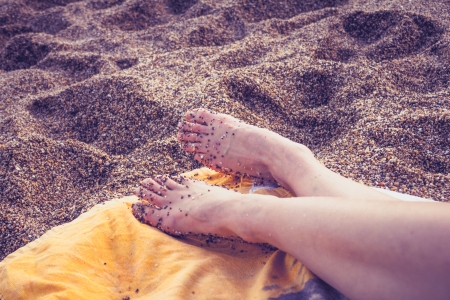 Close up on a young woman s feet on the beachの写真素材