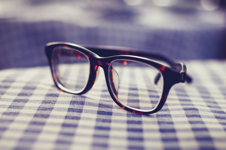 Pair of glasses on a checkered tableclothの写真素材