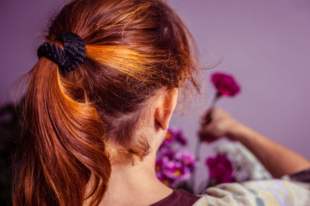 Young woman arranging a bouquet of colorful flowers