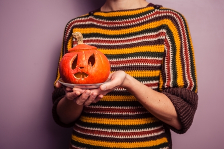 Young woman holding a halloween lanternの写真素材