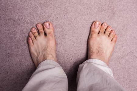 Man s bare feet on carpetの写真素材