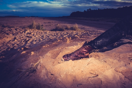 Hiker relaxing leg on the beachの写真素材