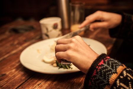 Young woman s hands as she is eating breakfast