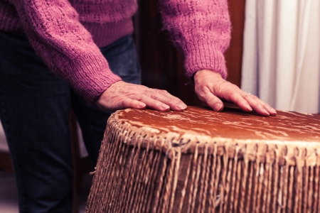 Old woman playing the bongo drumsの写真素材
