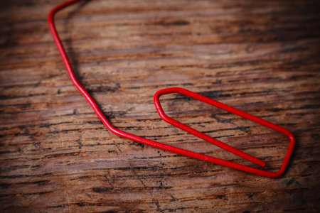 Crumbled up an useless red paperclip