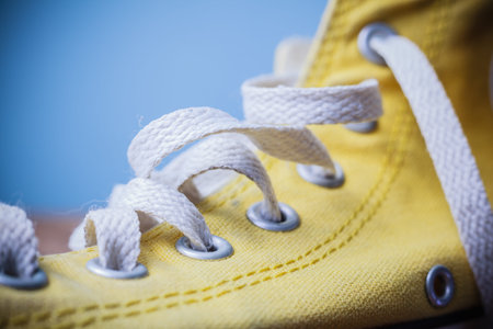 Close up on a yellow shoe and laces