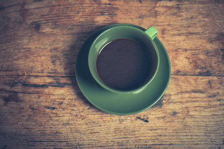 A cup of black coffee on a wooden tableの写真素材