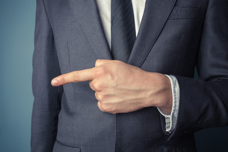 Closeup on a young businessman pointing leftの写真素材