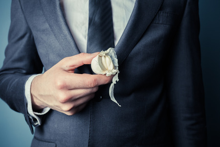 Young businessman is holding a garlicの写真素材