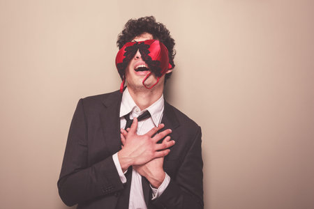 Young businessman is wearing a sexy bra on his face