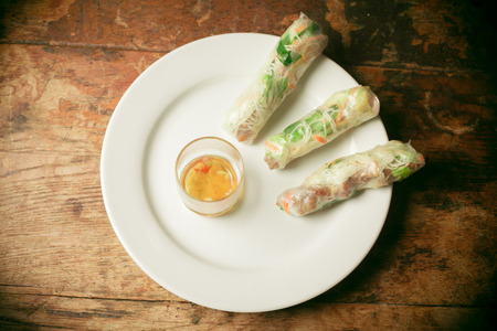 Summer rolls and fish sauce on a plateの写真素材