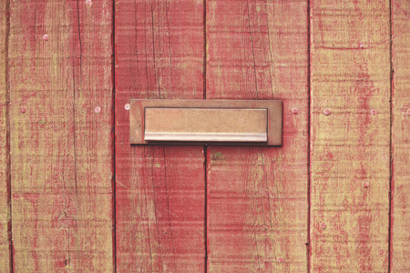 Old wooden door with a brass letterboxの写真素材