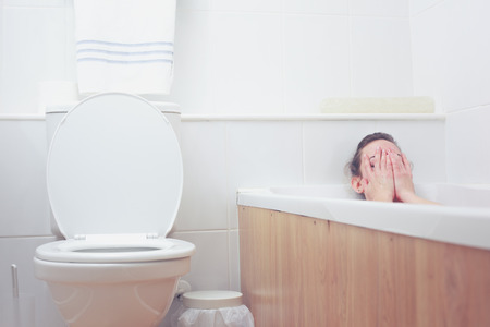 Young woman is in the bathtub having a bathの写真素材