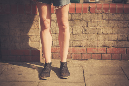 Closeup on a young woman s leg in the streetの写真素材