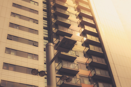 An apartment block and a stret lamp at sunsetの写真素材