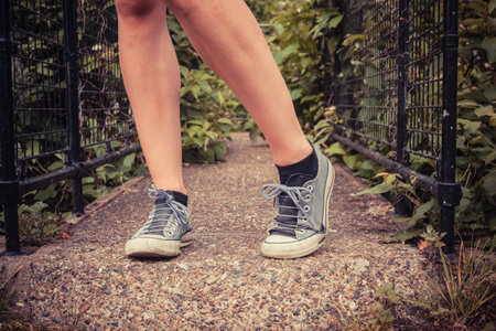 Close up on the legs of a young woman as she is standing outside in nature on a spring day