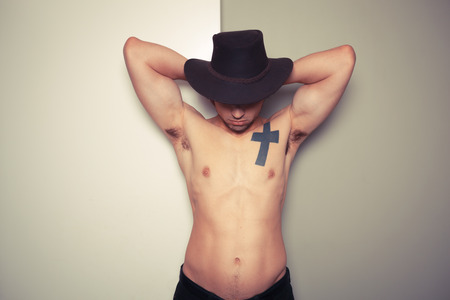 Sexy shirtless young cowboy posingの写真素材