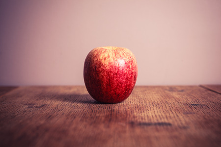 A royal gala apple on a wooden tableの写真素材