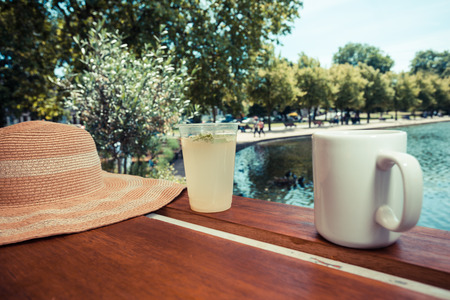 Drinks by the lake in a park on a summer dayの写真素材