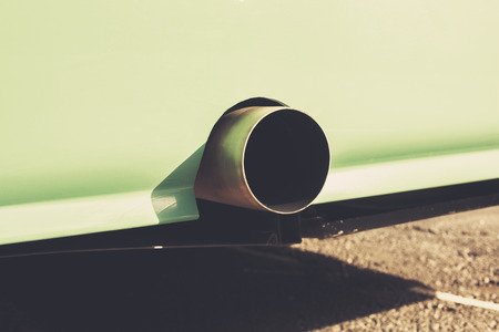 Close up on an exhaust pipe on a turqouise vehicleの写真素材