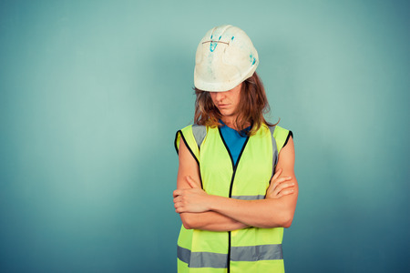 A young female engineer is wearing a high vis vest and a hardhatの写真素材