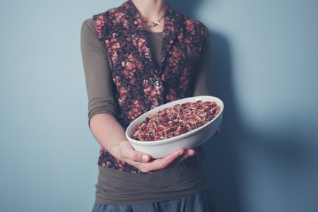 Young woman holding a pecan pieの写真素材