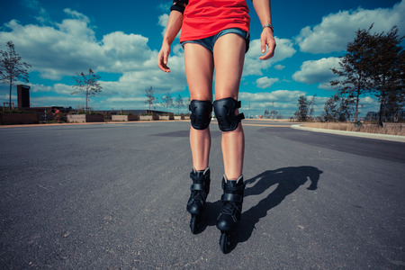 A young woman is rollerblading on a sunny dayの写真素材
