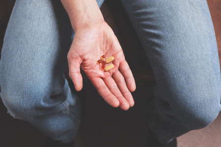 A male hand with pillsの写真素材