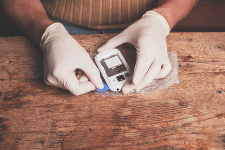 A technician is fixing and replacing the broken screen on a smart phoneの写真素材