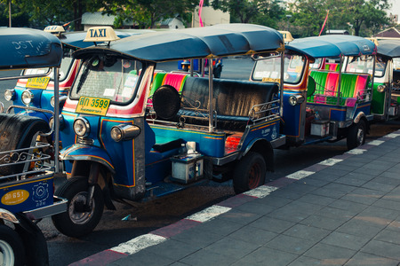 Bangkok - January 4, 2015. A row of tuktuks parked by the roadside in Bangkok, Thailand,のeditorial素材