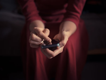 A young woman is using a smart phone at home