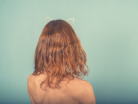 A young woman is wearing a hairband with cat earsの写真素材