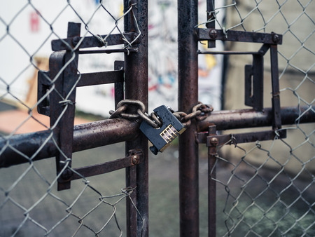 A padlock on a rusty old gateの写真素材