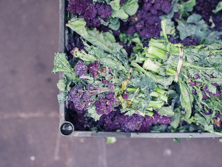 Purple broccoli in a box at a street marketの写真素材