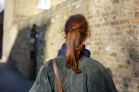 A young woman is walking in the streetの写真素材