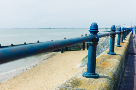 A rusty old railing by the seasideの写真素材