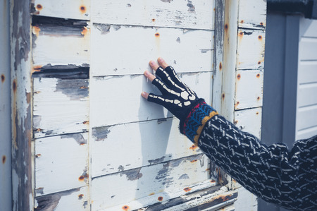 A young woman is touching a wooden structureの写真素材