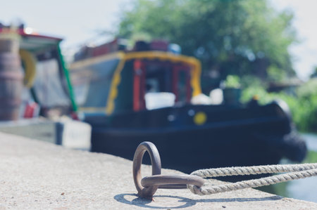 Focus on a rope used to moor some houseboats in a canal