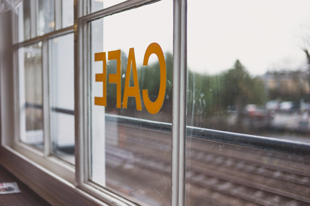 Looking through the window of a cafe by the railway tracksの写真素材