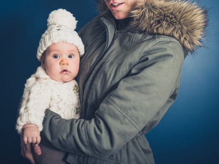 A young mother and baby in winter clothesの写真素材